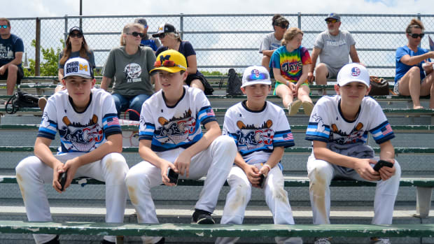 Members of a youth team from Northville, Michigan watch the Michigan Wolverines practice at Creighton University.